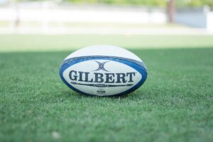 Rugby ball resting on a pitch